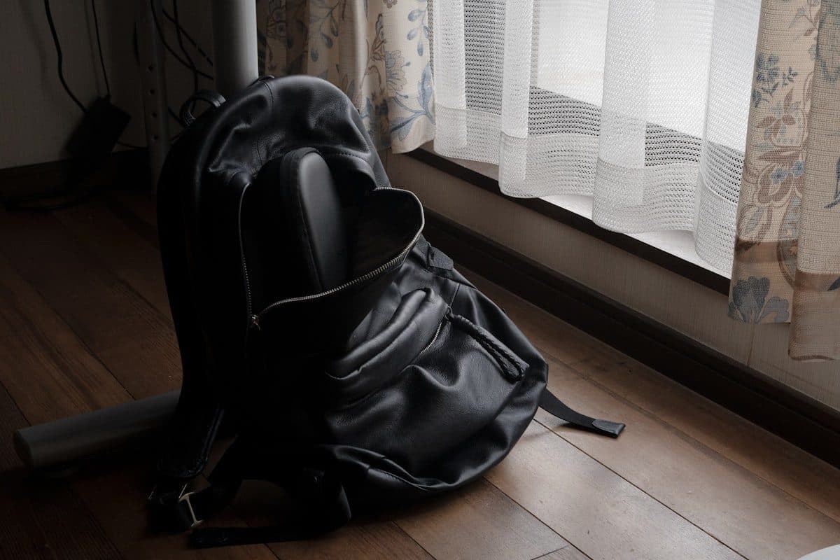 Black backpack by a window