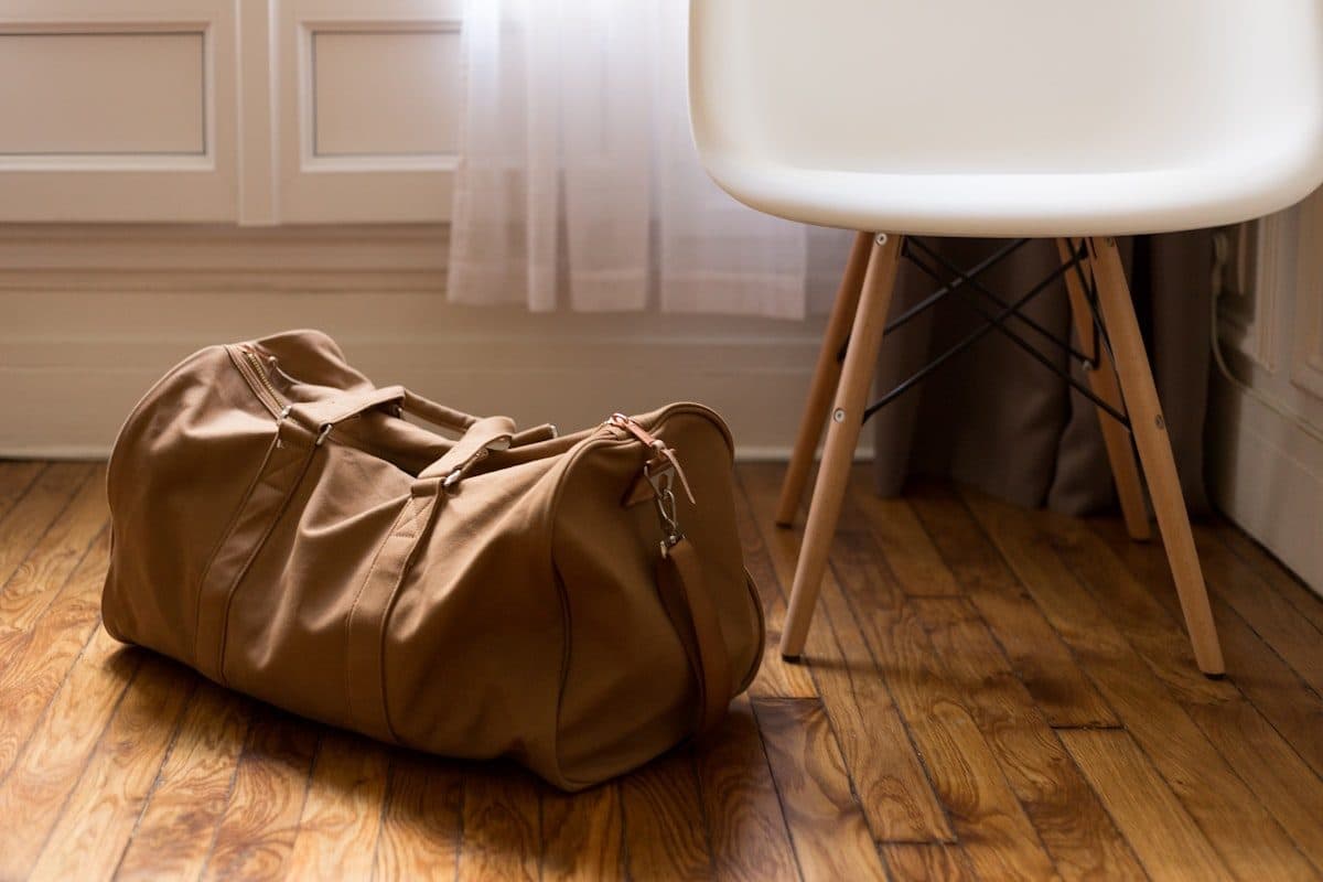 Brown duffel bag on a wooden floor
